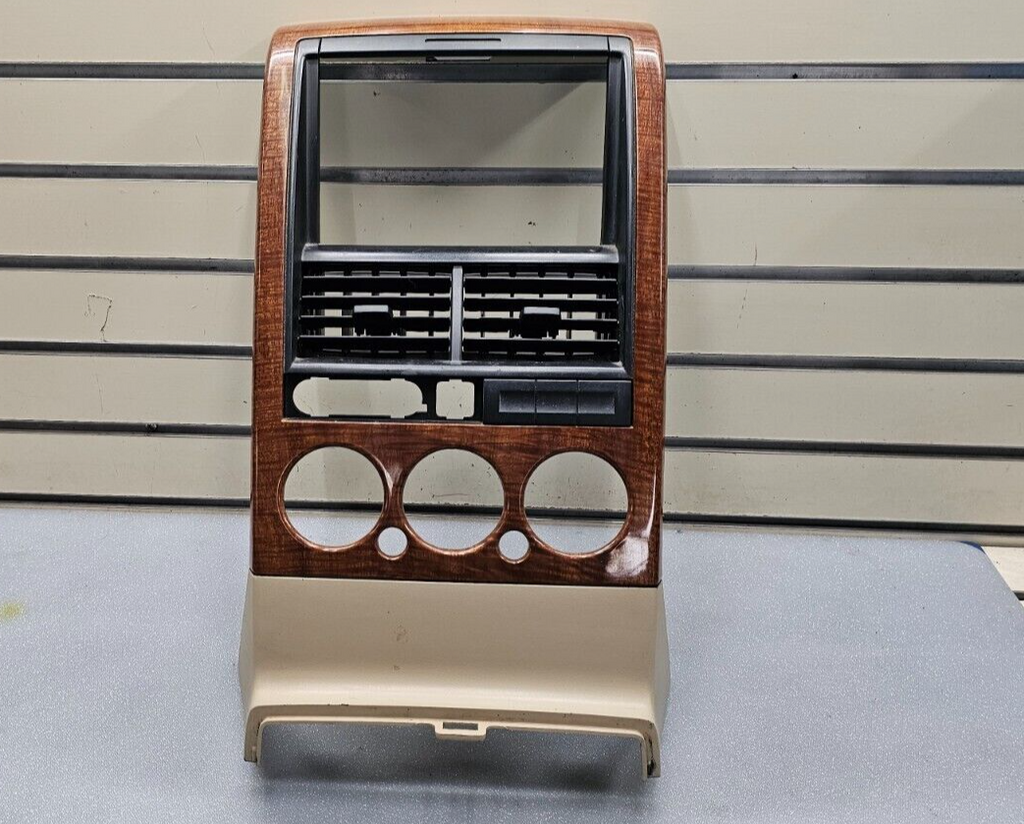 06-10 EXPLORER DASH AM FM RADIO STEREO DISPLAY CLIMATE PANEL BEZEL WOOD/TAN