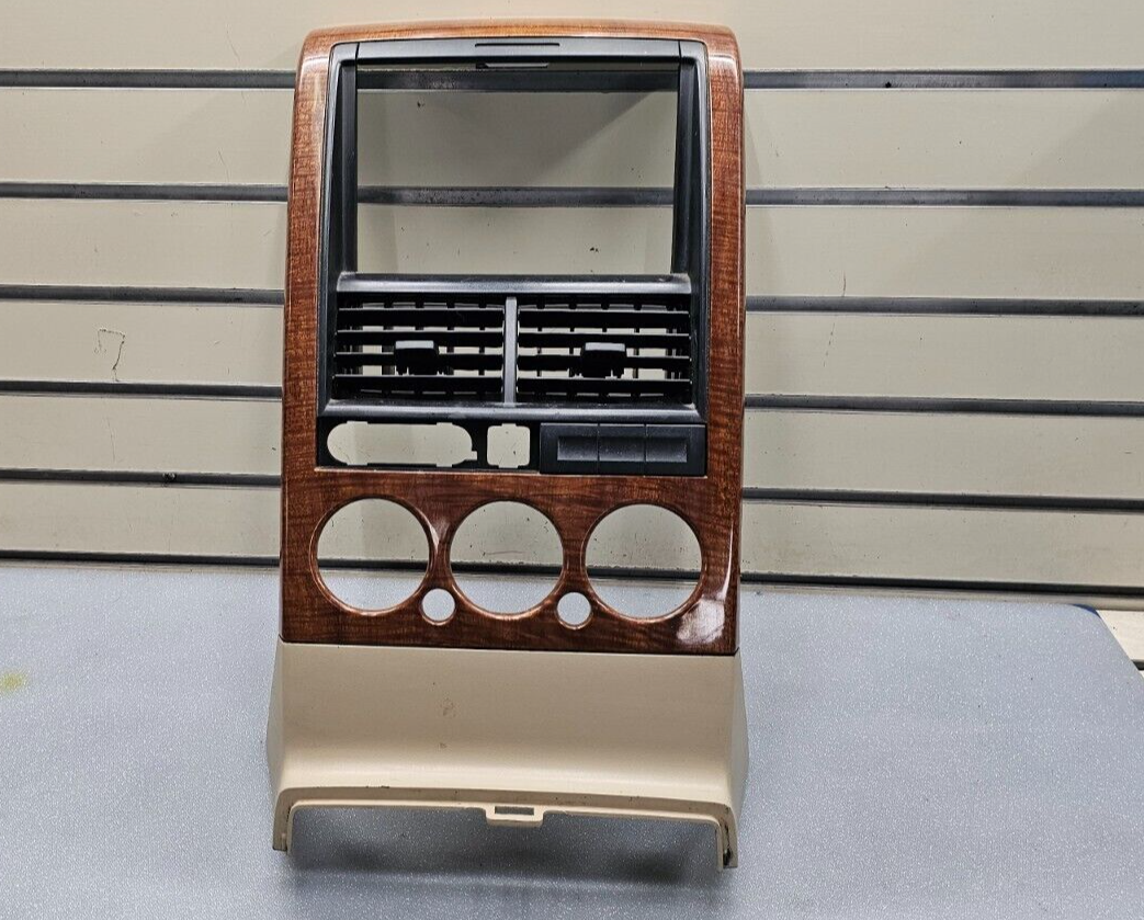 06-10 EXPLORER DASH AM FM RADIO STEREO DISPLAY CLIMATE PANEL BEZEL WOOD/TAN